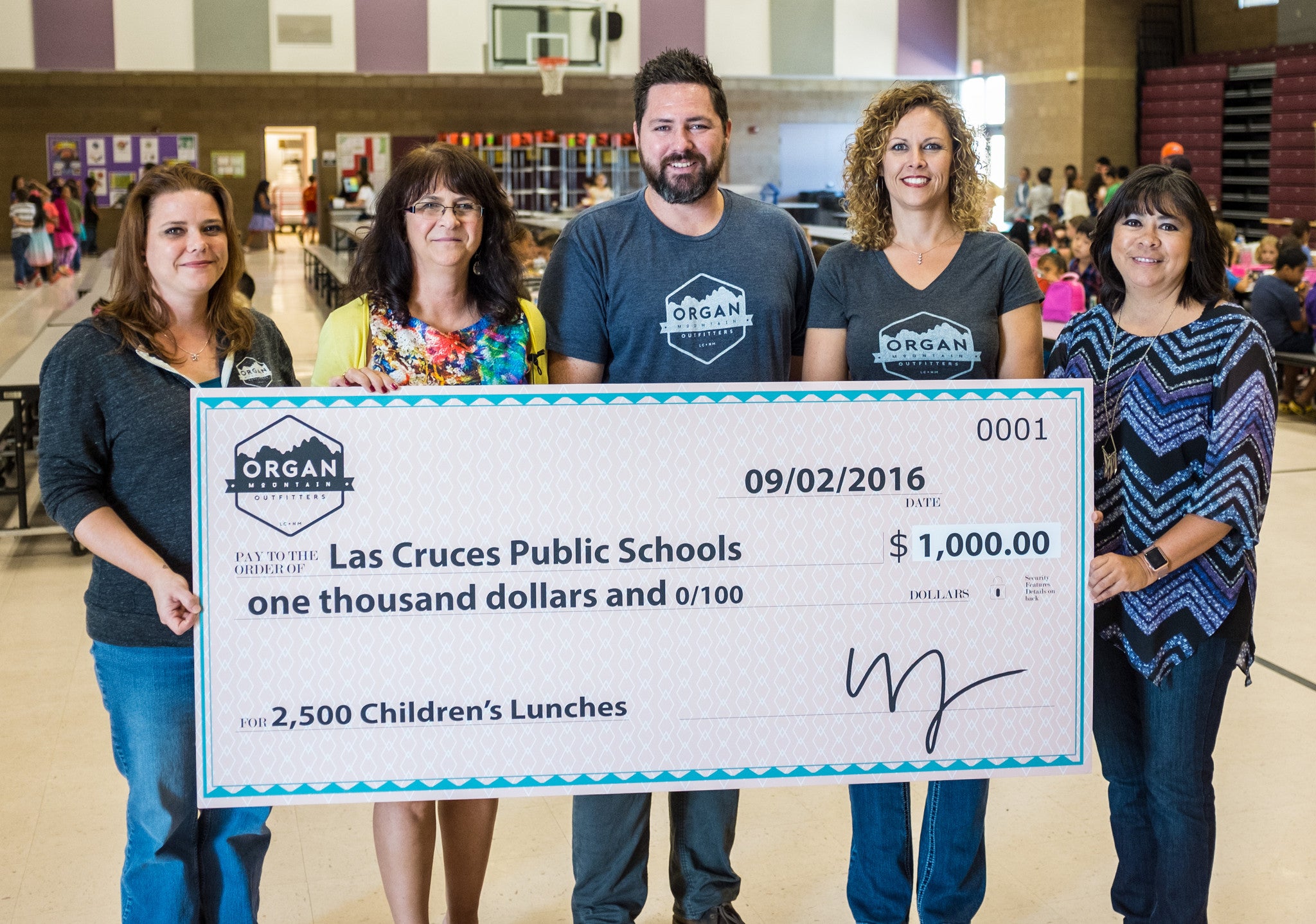 Organ Mountain Outfitters Presents A $1,000 Check to the Las Cruces Public Schools